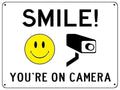 UV071 SMILE YOU'RE ON CAMERA Safety Metal Aluminium Plaque Sign Door Gate A4