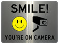 UV071 SMILE YOU'RE ON CAMERA Safety Metal Aluminium Plaque Sign Door Gate A4